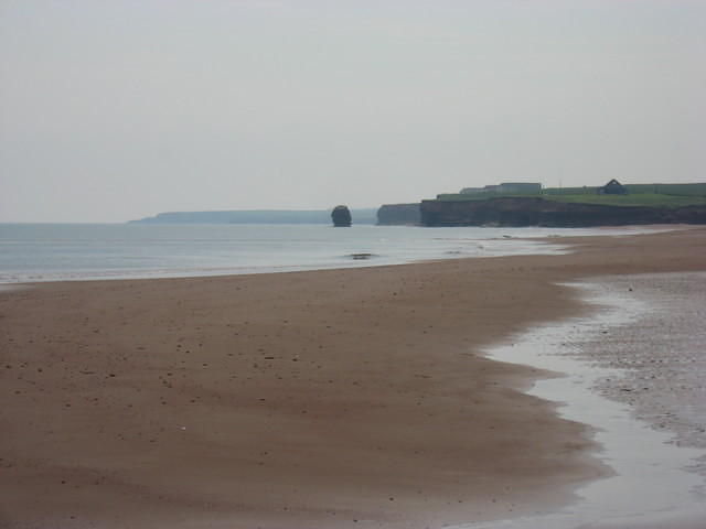 Area east of Penderosa Beach.  Rock in water was once part of cliff running out into the water