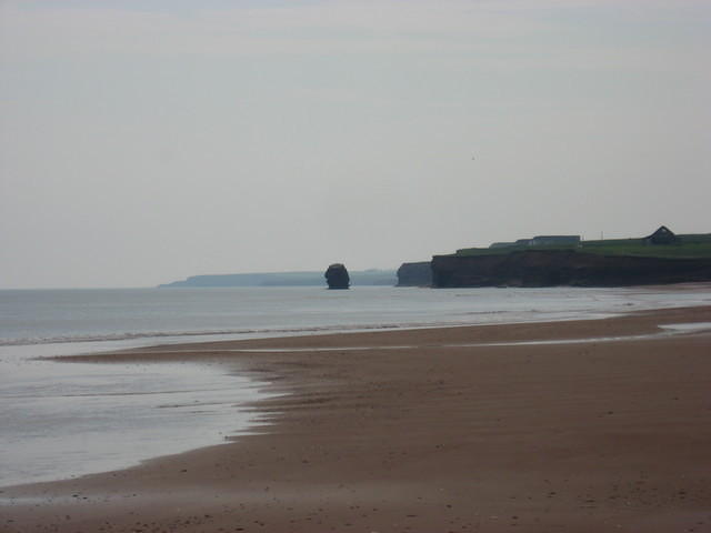 Area east of Penderosa Beach.  Rock in water was once part of cliff running out into the water