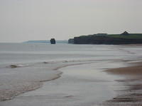 Area east of Penderosa Beach.  Rock in water was once part of cliff running out into the water